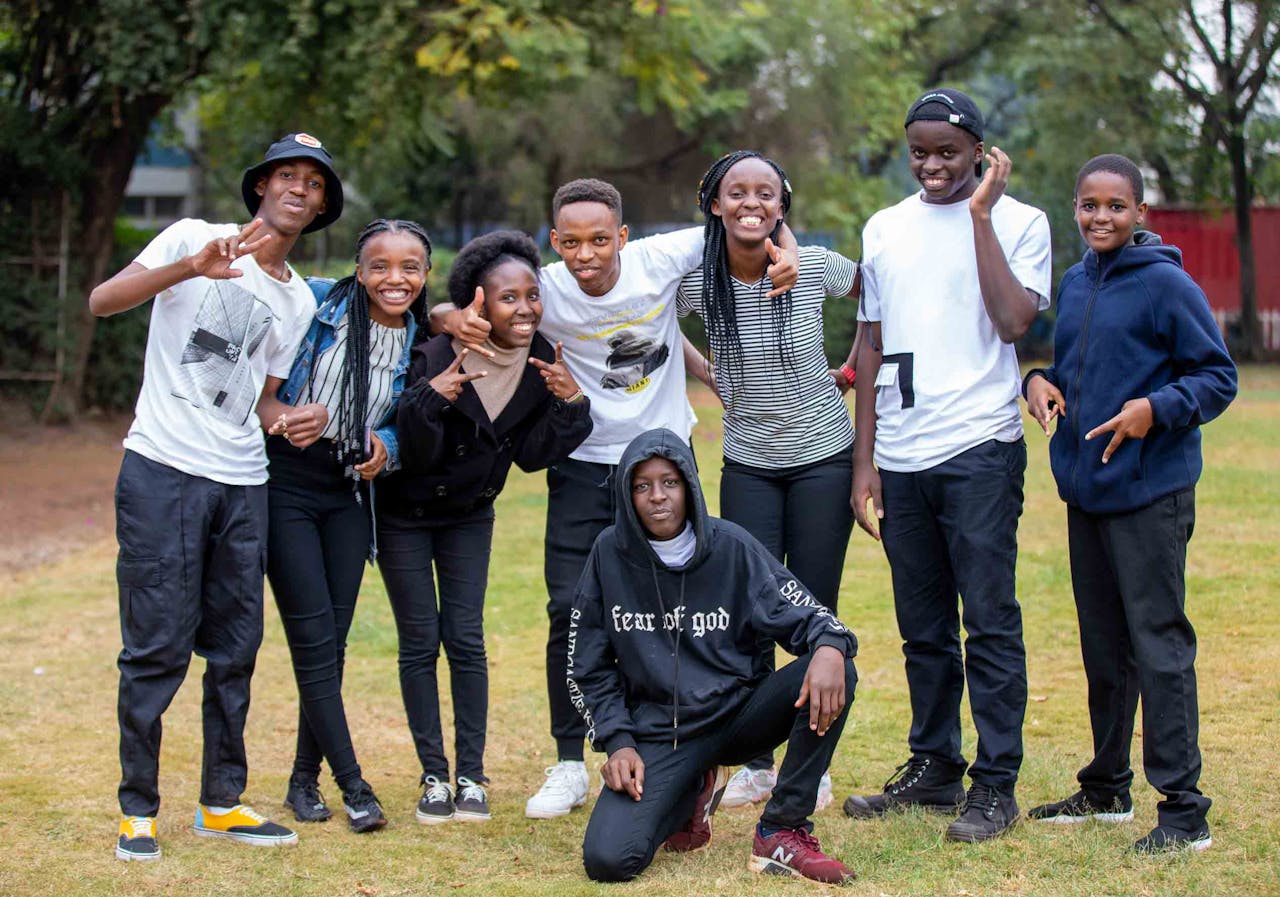 A joyful group of young friends posing together outdoors, showcasing friendship and happiness.